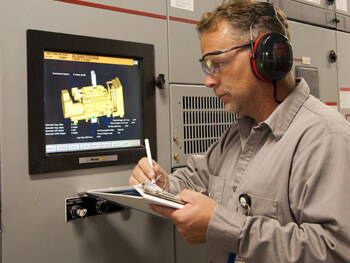 Technician assessing a mechanical system control panel