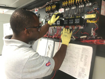 ESIS technician assessing building automation maintenance for a custom control system